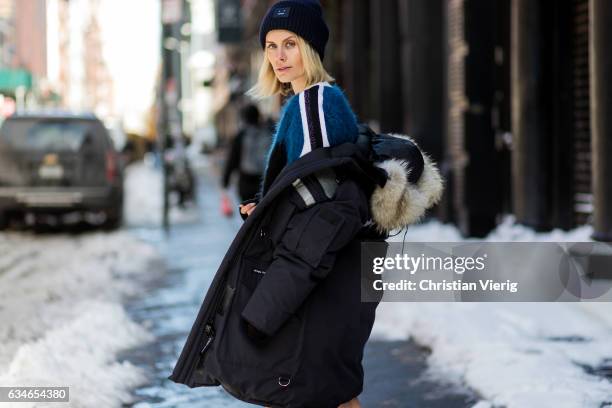 Lisa Hahnbueck wearing Canada Goose Resolute Parka, Louis Vuitton RTW Mohair Knit, Naplack And Leather Miniskirt, Louis Vuitton STAR TRAIL ANKLE...