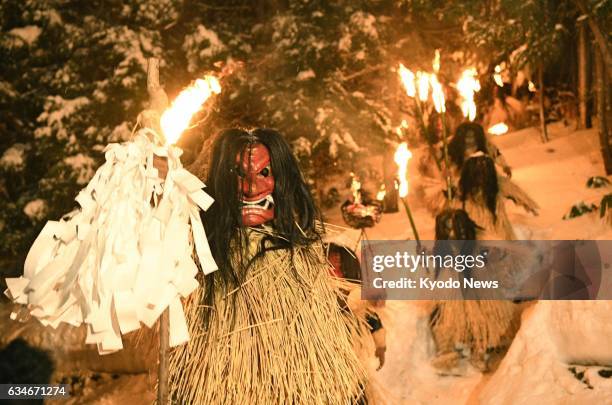 Men disguised as "Namahage" descend a snowy mountain carrying torches on Feb. 10 during the Namahage Sedo Festival at Shinzan Shrine in the...