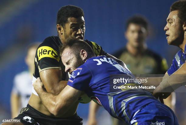 Waqa Blake of the Panthers is tackled by Matt Frawley of the Bulldogs during the NRL Trial match between the Canterbury Bulldogs and the Penrith...