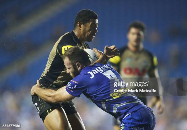 Waqa Blake of the Panthers is tackled by Matt Frawley of the Bulldogs during the NRL Trial match between the Canterbury Bulldogs and the Penrith...