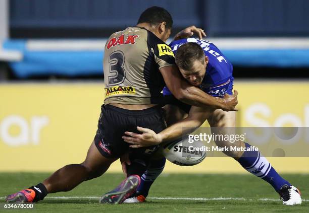 Brett Morris of the Bulldogs is tackled by Waqa Blake of the Panthers during the NRL Trial match between the Canterbury Bulldogs and the Penrith...