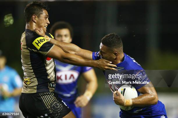 Marcelo Montoya of the Bulldogs is tackled by Te Maire Martin of the Panthers during the NRL Trial match between the Canterbury Bulldogs and the...