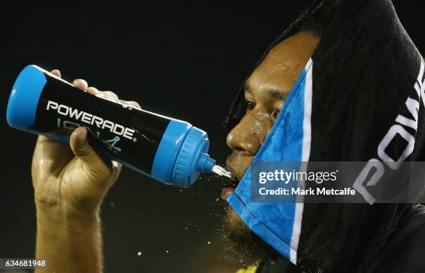 Dean Whare of the Panthers cools down with a wet towel and a drink during the NRL Trial match between the Canterbury Bulldogs and the Penrith...