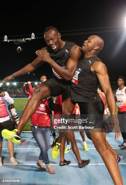 Usain Bolt and Asafa Powell of Usain Bolt's All-Star team celebrate after winning the Mens 150 Metre Race during the Melbourne Nitro Athletics Series...