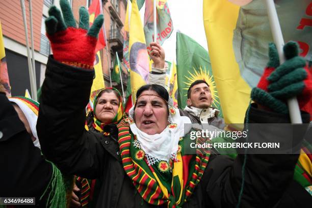 Kurds wave flags and banners of convicted Kurdistan Worker's Party leader Abdullah Ocalan during a demonstration by several thousand people from all...