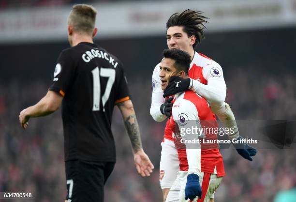 Alexis Sanchez of Arsenal celebrates scoring the opening goal with his team mate Hector Bellerin during the Premier League match between Arsenal and...