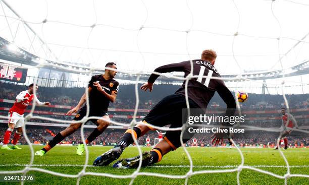 Sam Clucas of Hull City clears the header by Lucas Perez of Arsenal with his arm resulting in a penalty kick to Arsenal during the Premier League...