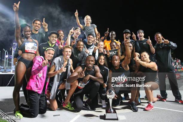 Usain Bolt and Asafa Powell of Usain Bolt's All-Star team celebrate with the trophy after winning the event during the Melbourne Nitro Athletics...