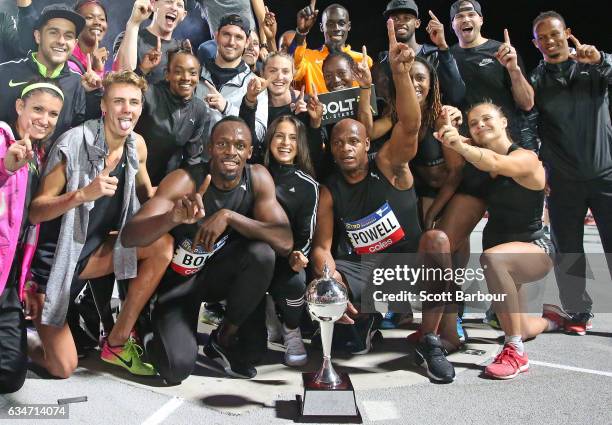 Usain Bolt and Asafa Powell of Usain Bolt's All-Star team celebrate with the trophy after winning the event during the Melbourne Nitro Athletics...