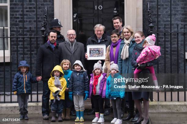 Labour peer Lord Dubs accompanied by religious and community leaders and foster carers hands in a petition calling on the Prime Minister to...