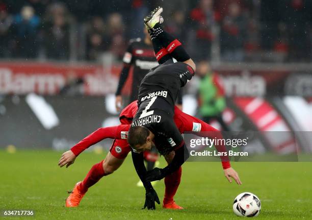 Chicharito of Bayer Leverkusen is challenged by Bastian Oczipka of Frankfurt during the Bundesliga match between Bayer 04 Leverkusen and Eintracht...