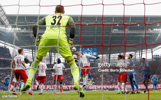 Kyriakos Papadopoulos of Hamburger SV scores his team's first goal with a header against goalkeeper Peter Gulacsi of RB Leipzig during the Bundesliga...