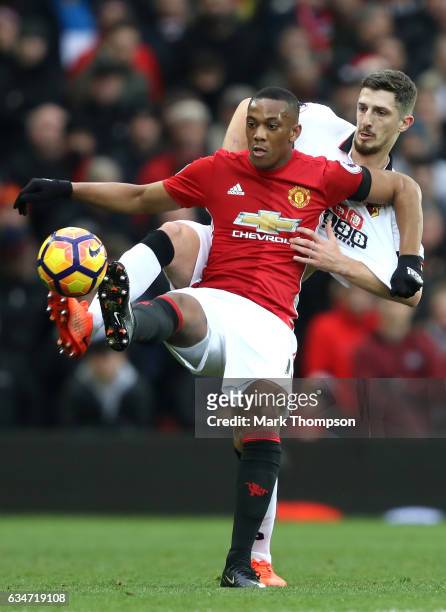 Anthony Martial of Manchester United controls the ball under pressure of Craig Cathcart of Watford during the Premier League match between Manchester...