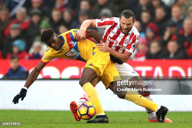 Wilfried Zaha of Crystal Palace and Erik Pieters of Stoke City compete for the ball during the Premier League match between Stoke City and Crystal...