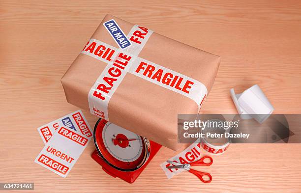 parcel to post on scales - fragile sign stock pictures, royalty-free photos & images