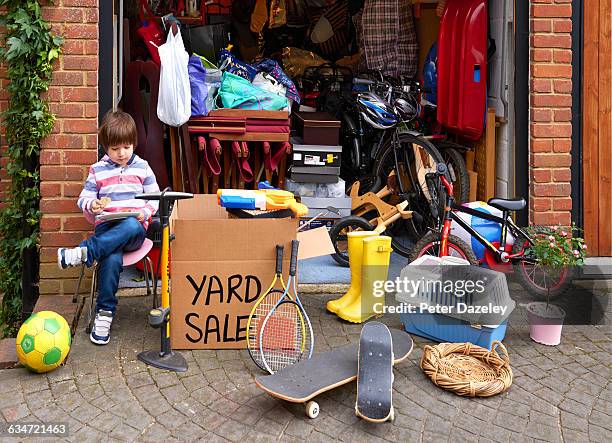 young boy with yard sale - ガレージセール ストックフォトと画像