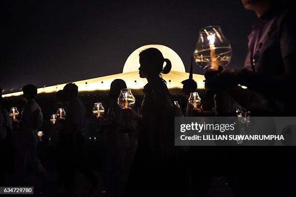 Buddhist devotees take part in a candlelight procession to mark Makha Bucha Day at Wat Dhammakaya temple, just north of Bangkok, on February 11,...