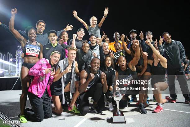 Usain Bolt and Asafa Powell of Usain Bolt's All-Star team celebrate with the trophy after winning the event during the Melbourne Nitro Athletics...