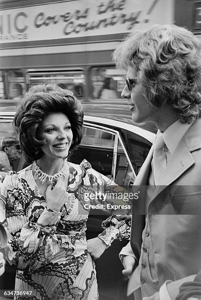 English actress Joan Collins wearing a midi-dress, UK, 29th May 1970.