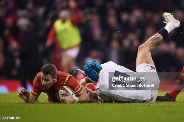 Liam Williams of Wales dives past Jack Nowell of England to score his team's first try during the RBS Six Nations match between Wales and England at...