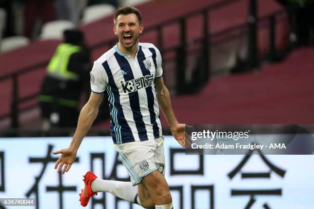 Gareth McAuley of West Bromwich Albion celebrates after scoring a goal to make it 2-2 during the Premier League match between West Ham United and...
