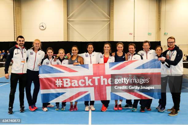 Jocelyn Rae, Heather Watson, captain Anne Keothavong, Laura Robson and Johanna Konta of Great Britain celebrate with fellow team members after the...