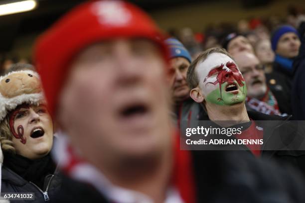 Wales fan with a painted face sings in the crowd during the Six Nations international rugby union match between Wales and England at the Principality...