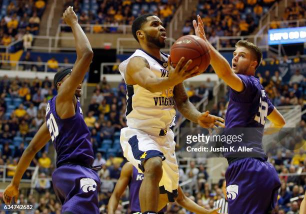 Tarik Phillip of the West Virginia Mountaineers drives to the rim against Dean Wade of the Kansas State Wildcats at the WVU Coliseum on February 11,...