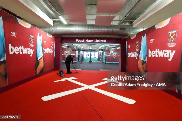 Cleaner vacuums the carpet in the tunnel before the Premier League match between West Ham United and West Bromwich Albion at London Stadium on...