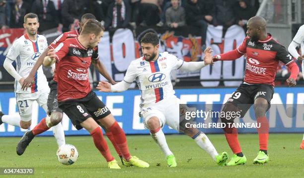 Guingamp's French defender Lucas Deaux and Guingamp's French forward Yannis Salibur vie with Lyon's French midfielder Nabil Fekir during the French...