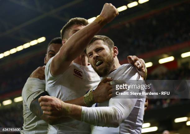 Elliot Daly of England is congratulated by teammates Nathan Hughes and Owen Farrell of England after scoring the match winning try during the RBS Six...