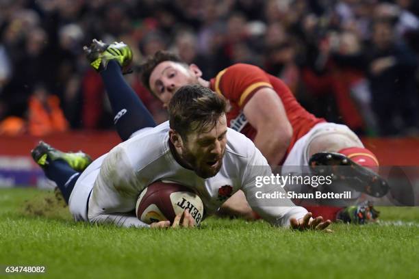 Elliot Daly of England dives past Alex Cuthbert of Wales to score the match winning try during the RBS Six Nations match between Wales and England at...