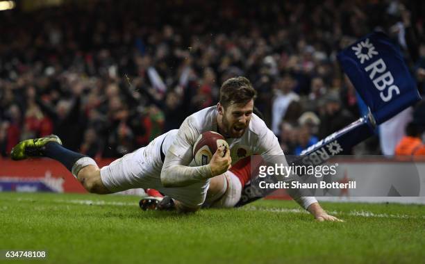 Elliot Daly of England dives past Alex Cuthbert of Wales to score the match winning try during the RBS Six Nations match between Wales and England at...
