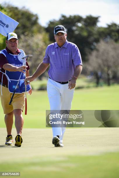 Kenny Perry hands his club to his caddy after putting on the second hole during the second round of the PGA TOUR Champions Allianz Championship at...