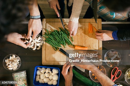 Vegetables being cut in cooking class Vegetables being cut in cooking class