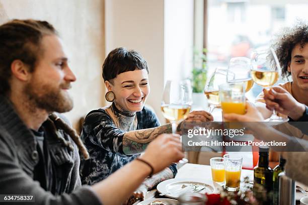 group of young people enjoying a glass of wine - freunde restaurant stock-fotos und bilder