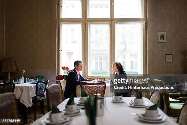 mature couple having breakfast in an old hotel - fancy restaurant stock pictures, royalty-free photos & images