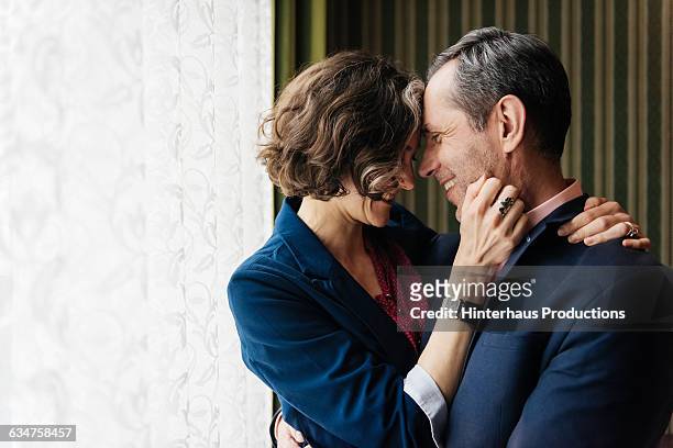 mature couple embracing each other - mann 50 style stock-fotos und bilder