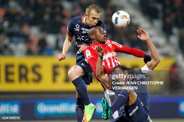 Montpellier's Czech defender Lukas Pokorny heads the ball above Nancy's French forward Junior Dale and his teammate Montpellier's Brazilian defender...