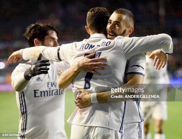 Real Madrid's Portuguese forward Cristiano Ronaldo is congratulated by teammate French forward Karim Benzema after scoring his team's first goal...
