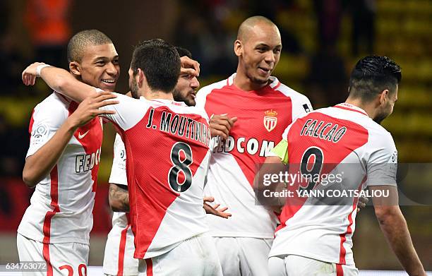 Monaco's French forward Kylian Mbappe Lottin is congratulated by teammates after scoring a goal during the French Ligue 1 football match between AS...
