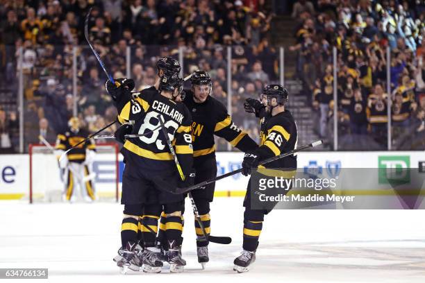 David Pastrnak of the Boston Bruins celebrates with Peter Cehlarik, Zdeno Chara and David Krejci after scoring against the Vancouver Canucks during...