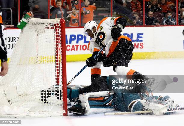 Wayne Simmonds of the Philadelphia Flyers scores the game winning goal in overtime as Aaron Dell of the San Jose Sharks defends on February 11, 2017...