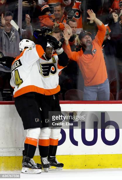 Wayne Simmonds of the Philadelphia Flyers is congratulated by teammate Sean Couturier after Simmonds scored the game winning goal in overtiime...