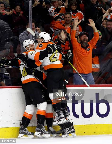 Wayne Simmonds of the Philadelphia Flyers is congratulated by teammates Nick Cousins and Sean Couturier after Simmonds scored the game winning goal...