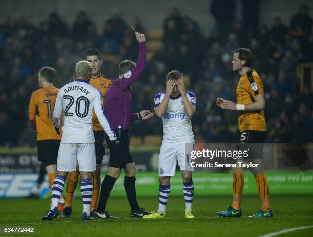 Matt Ritchie of Newcastle United receives a yellow card by Referee Craig Pawson during the Sky Bet Championship match between Wolverhampton Wanderers...