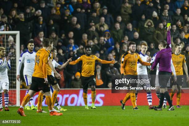 Matt Doherty of Wolverhampton Wanderers receives a yellow card by Referee Craig Pawson during the Sky Bet Championship match between Wolverhampton...