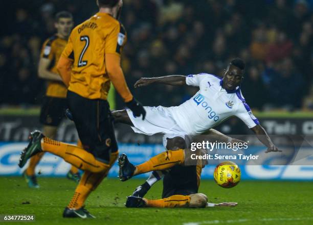 Christian Atsu of Newcastle United is wiped out whilst chasing the ball during the Sky Bet Championship match between Wolverhampton Wanderers and...