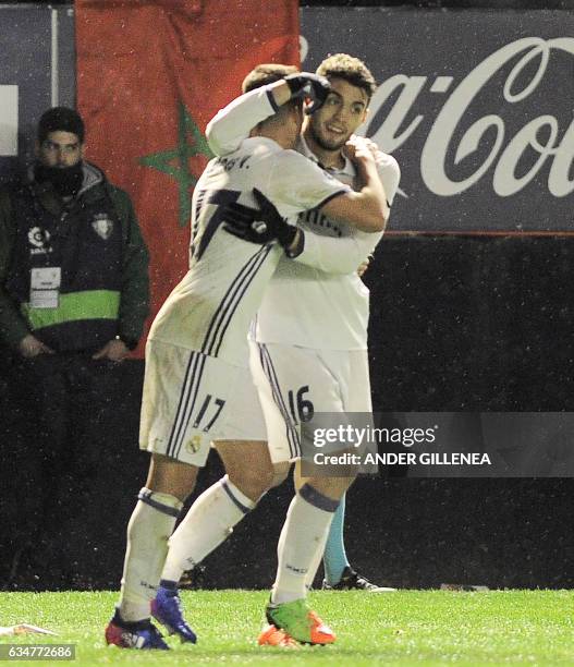 Real Madrid's forward Lucas Vazquez is congratulated by teammate Croatian midfielder Mateo Kovacic after scoring his team's third goal during the...