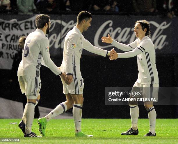 Real Madrid's defender Nacho Fernandez, Portuguese forward Cristiano Ronaldo and Croatian midfielder Luka Modric celebrate after forward Lucas...